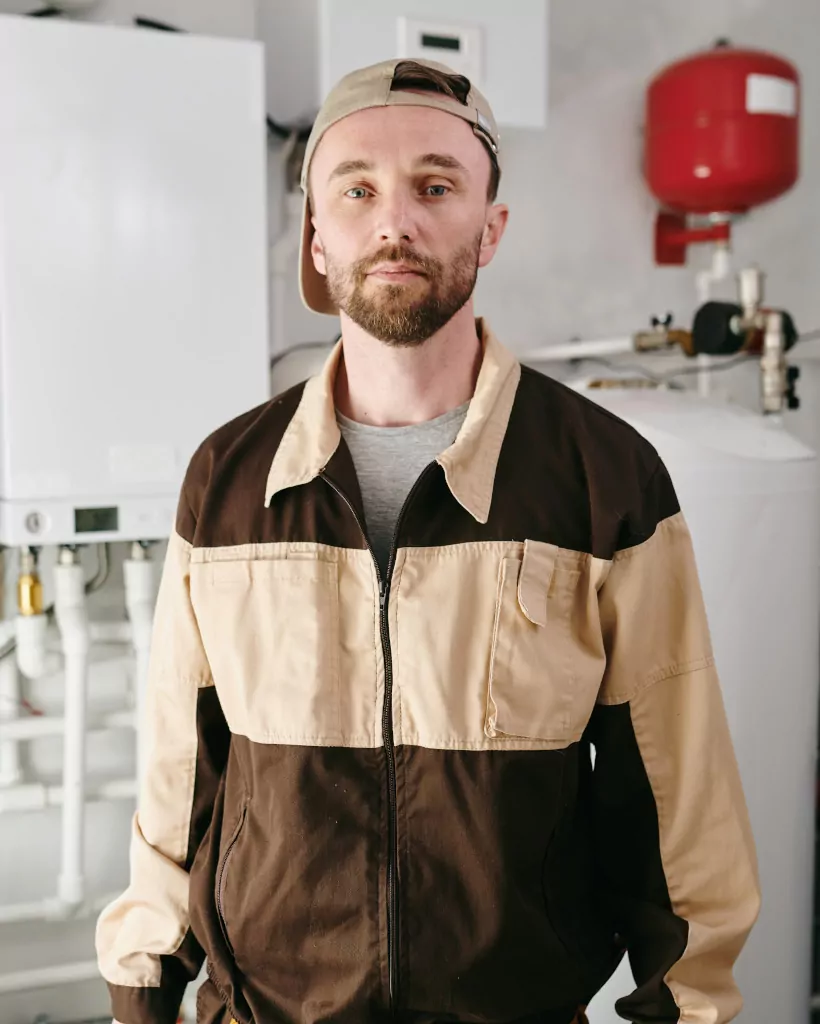 young repairman with toolbelt standing in toilet K4Q454M
